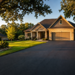 New asphalt driveway freshly paved in front of a Springfield MO home at golden hour