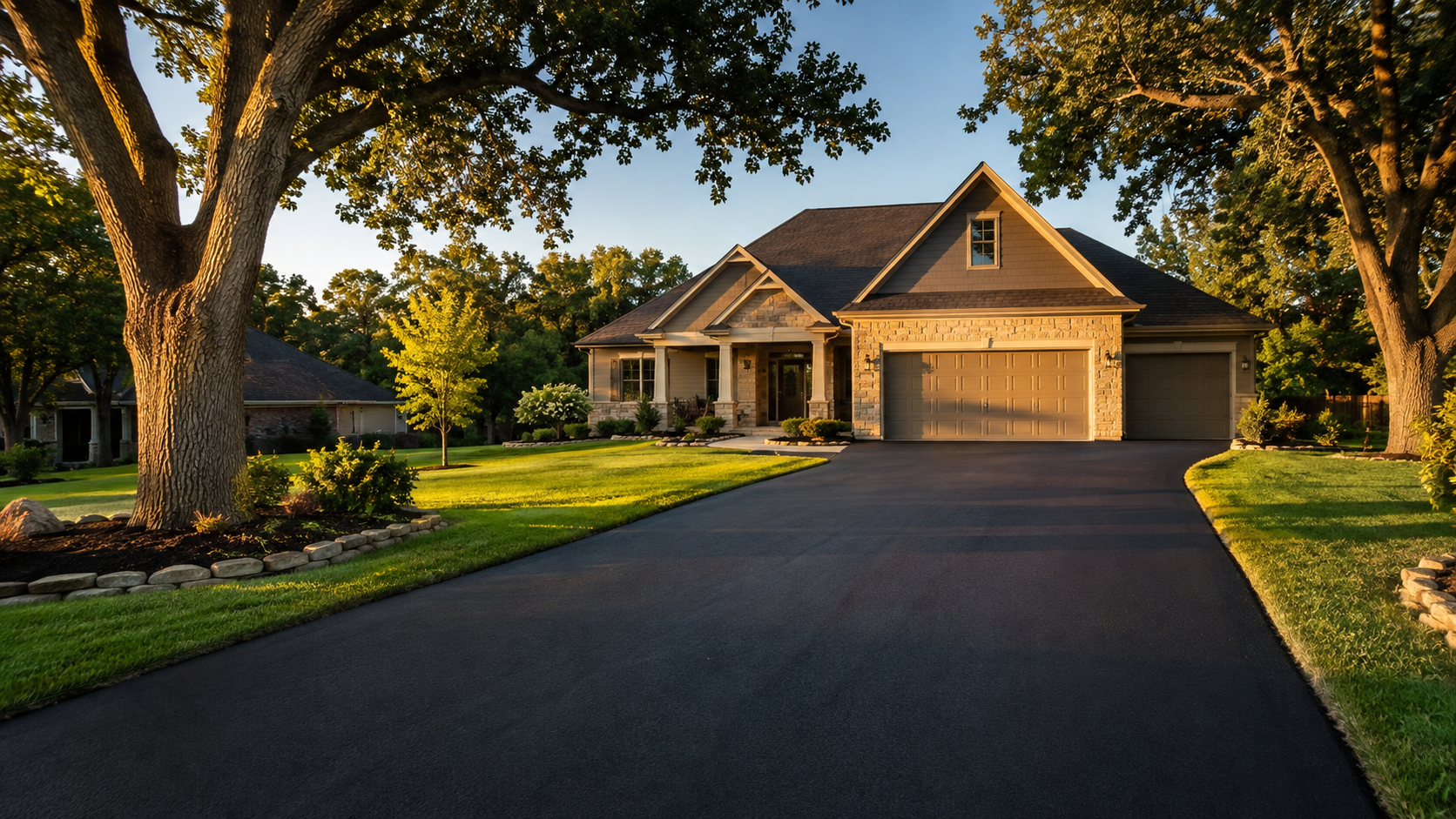 New asphalt driveway freshly paved in front of a Springfield MO home at golden hour